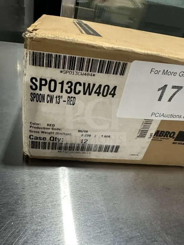 Box of 12 brand new Camwear 13" red plastic spoons, Model SPO13CW404. Labels show model and quantity.