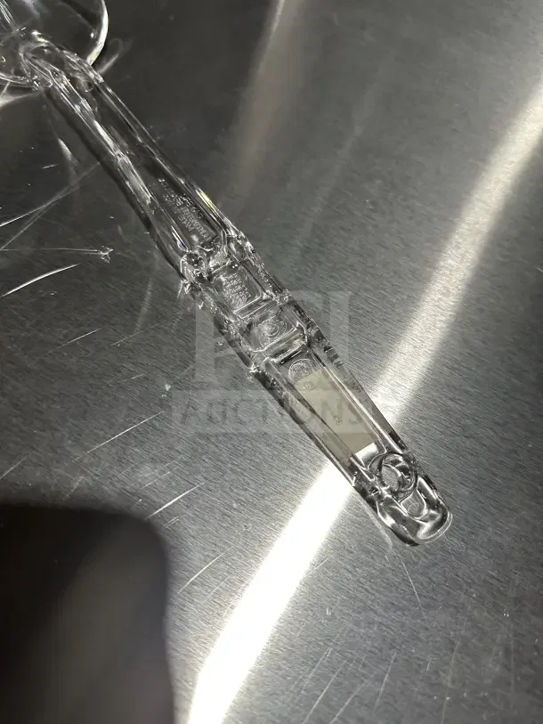 Cambro Camwear Series 13" clear polycarbonate deli spoon, model SPO13CW135, shown on a reflective surface.