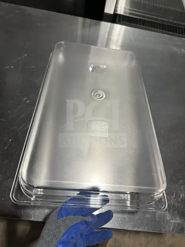 Brand new Thunder Group PLPA8002 clear polycarbonate full-size food pan, 2.5" deep, on a metal surface.
