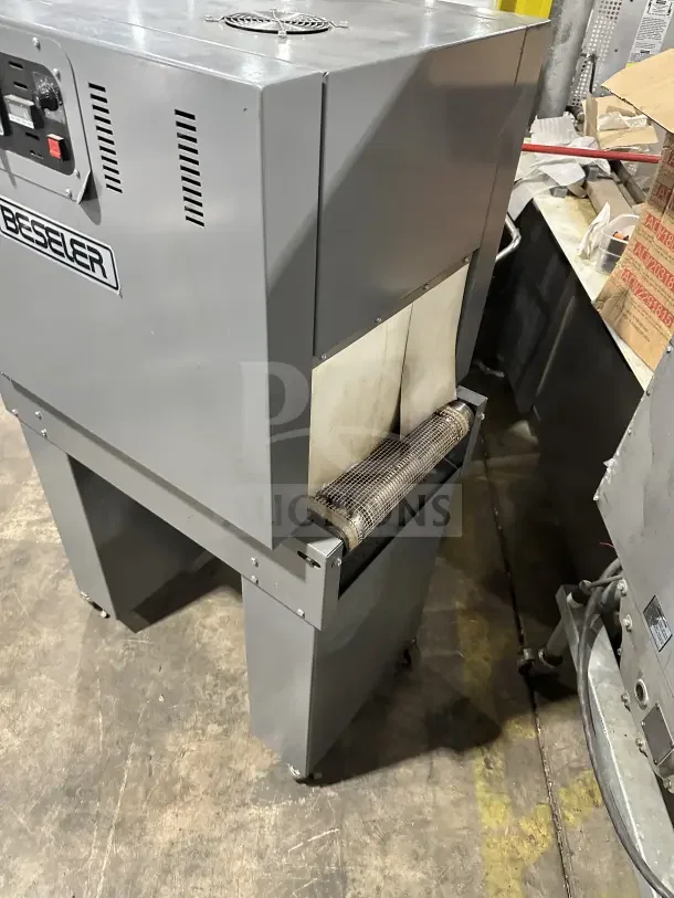 Beseler TD1610 shrink wrap system, electric, 220V, 1 phase, on casters, features control panel and sturdy metal build.