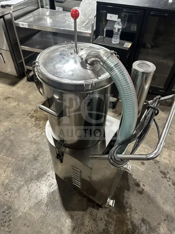 Stainless steel industrial kitchen appliance with red lever, hose attachment, and secure lid. Appears in good condition.