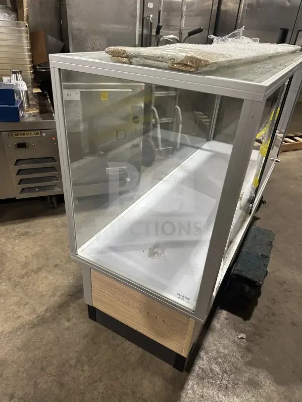 Commercial glass display case with extra-vision and wood base accent, in used condition. Tempered glass label visible.