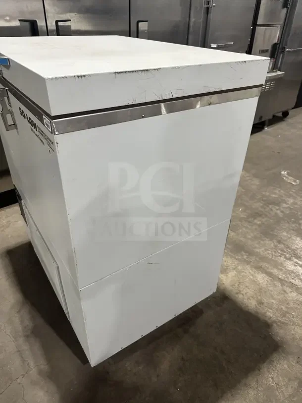 So-Low Commercial Chest Freezer, white, Model C85-5, SN: 20211693, 115V, 1 Phase, metal. Some surface wear visible.