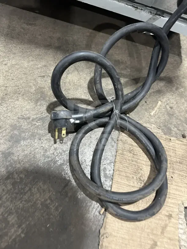So-Low C85-5 ultra-low temperature chest freezer power cord on concrete, black, 115V, for commercial use.
