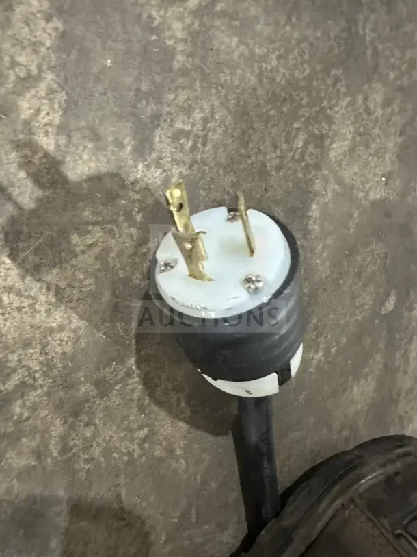 Close-up of a power plug for Fetco CBS2142XST commercial coffee brewer, showing prongs and connector details.