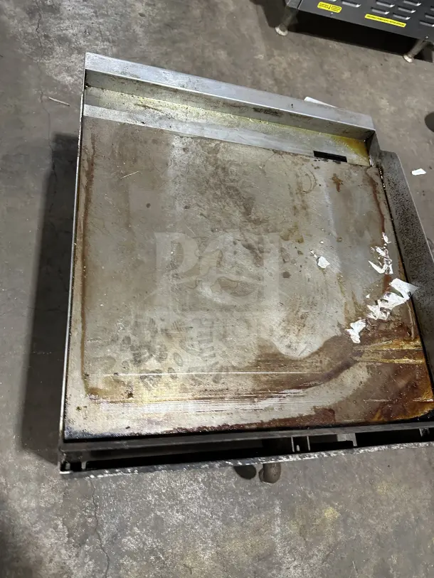 Vulcan VCRG24-T1 24" stainless steel natural gas countertop griddle on legs, showing signs of use. SN: DV1126322.