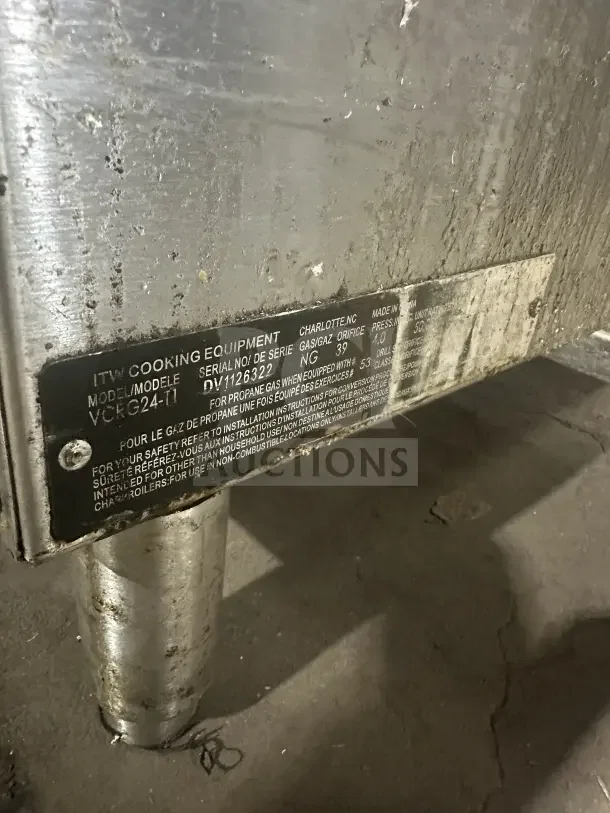 Vulcan VCRG24-T1 stainless steel griddle with natural gas power. Label shows model, serial DV1126322. Mounted on legs.
