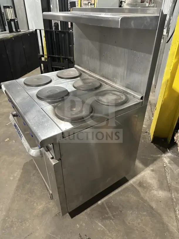 Imperial stainless steel electric 6-burner hot plate range/oven combo with backsplash, overhead shelf, and wired oven rack.