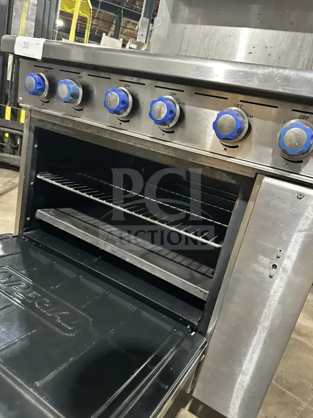 Imperial commercial stainless steel 6-burner hot plate range/oven combo with backsplash, overhead salamander shelf, and wired oven rack.
