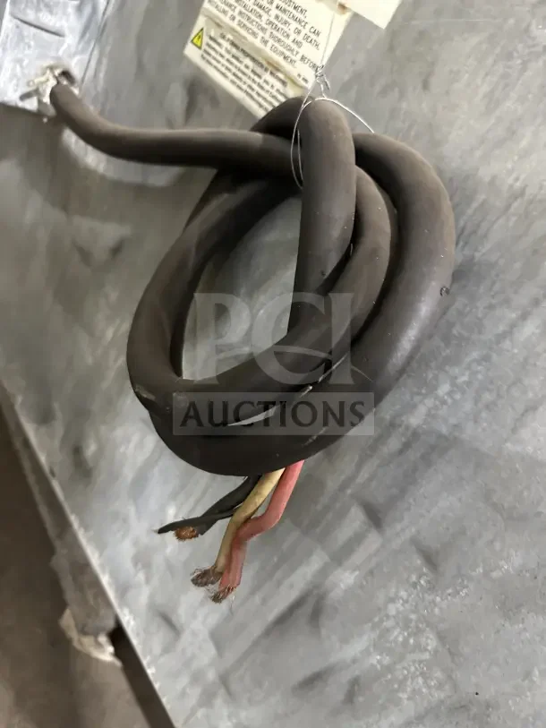 Cables and warning label on the back of an Imperial Commercial stainless steel electric 6 burner oven with salamander shelf.