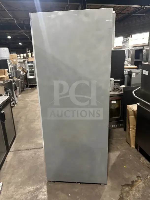 Commercial stainless steel 3-door sliding reach-in refrigerator merchandiser with poly-coated wire rack, in used condition.