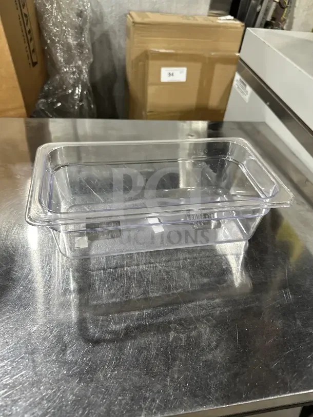 Winco SP7304 clear polycarbonate 1/6-size food pan on metal surface; commercial quality, excellent condition.