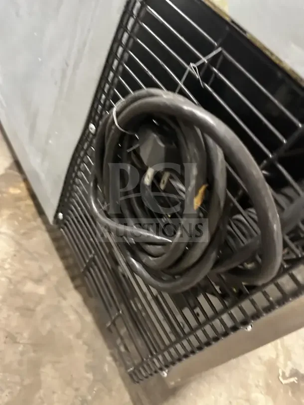 Turbo Air JUR-36 undercounter worktop refrigerator's side-mounted compressor with power cord, poly-coated wire rack visible.
