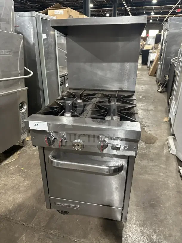 Southbend S241E stainless steel 4-burner natural gas range/oven with backsplash, salamander shelf, and wired oven rack on casters.