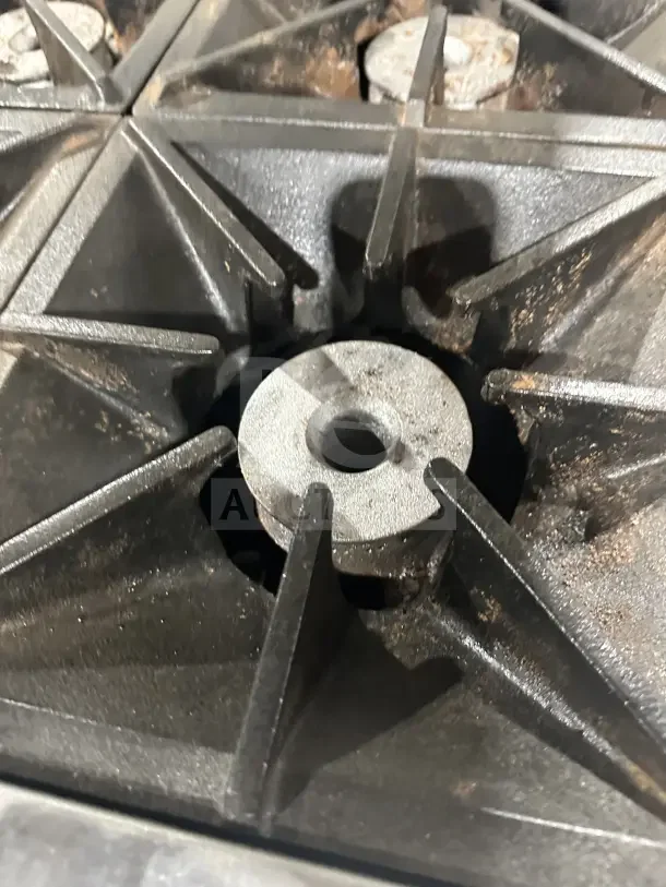 Southbend S241E 4-burner range close-up, showing cast iron grates in used condition; part of a stainless steel oven combo.
