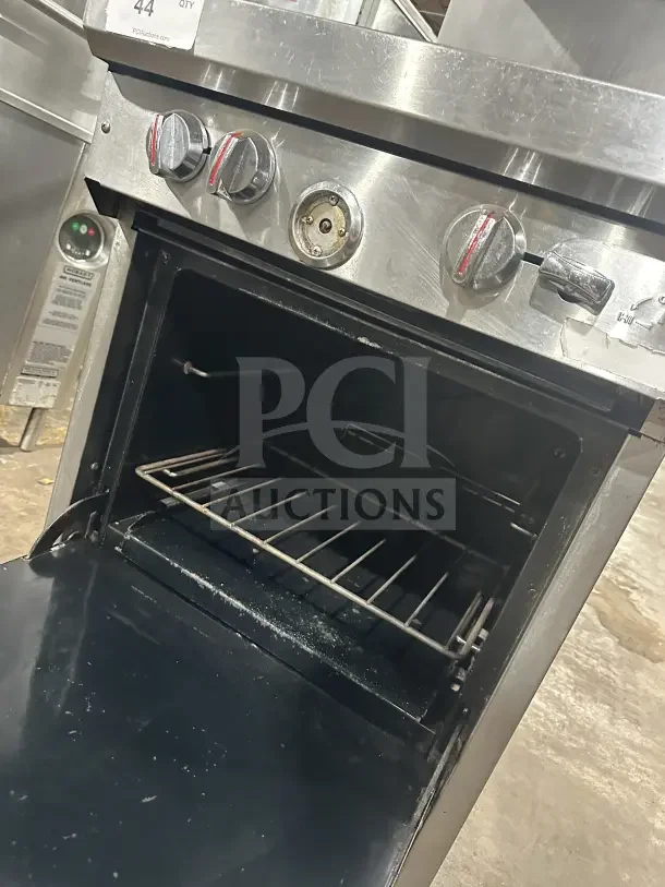 Southbend S241E commercial stainless steel 4-burner range/oven with backsplash, salamander shelf, and wired rack on casters.