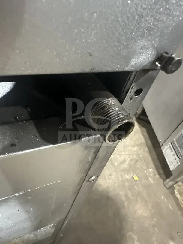 Close-up of Southbend stainless steel commercial range S241E, showing natural gas connection, in used condition.