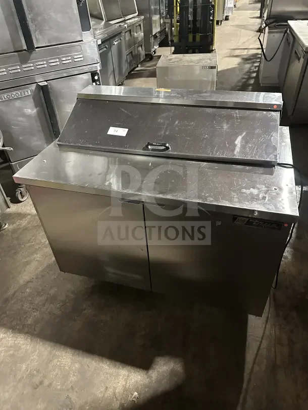 True commercial stainless steel 2-door refrigerated prep table, electric powered, visible model tag, solid condition.