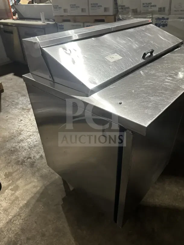 True commercial stainless steel 2-door refrigerated prep table, electric powered, slight surface wear, model label visible.
