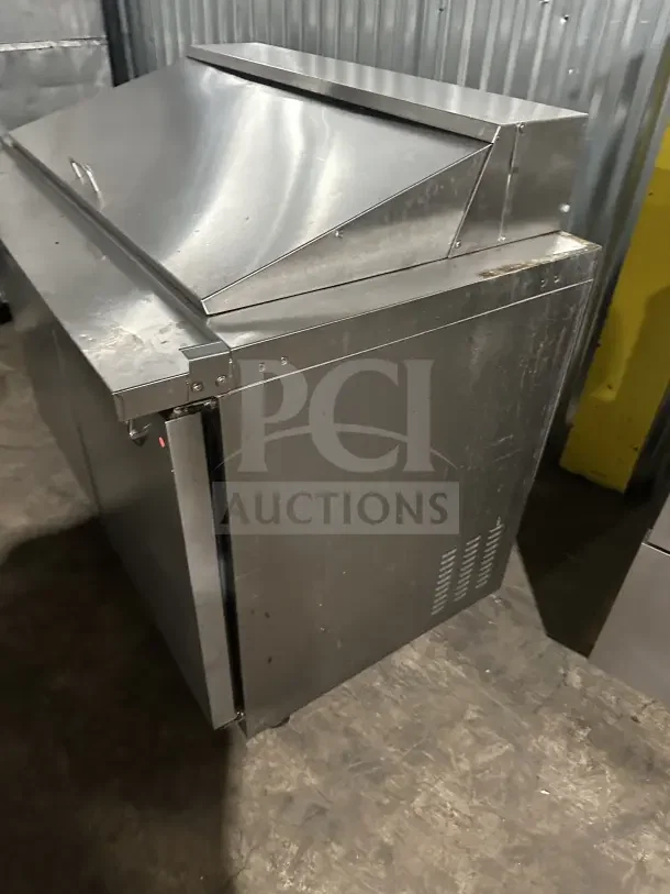 Kelvinator KCHMT418 commercial 2-door stainless steel prep table on casters, showing wear.