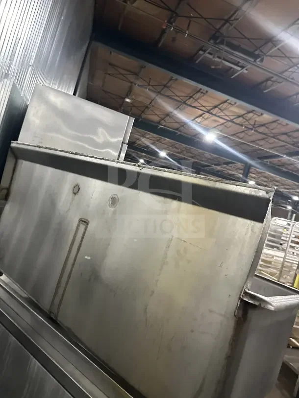 Commercial stainless steel two-compartment utility sink with legs, industrial-grade, with visible wear.