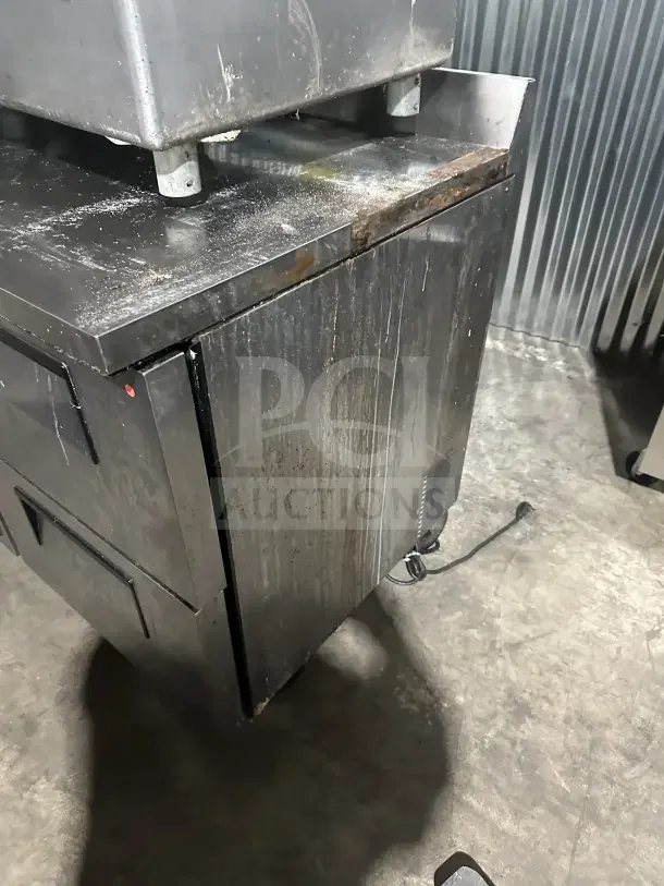 True TWT-48D-4 undercounter refrigerator with stainless steel worktop, four drawers, backsplash, and casters. Used condition.