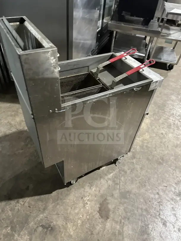Connerton CSGF4ADT 50lb stainless steel floor fryer with backsplash, basket hanger, fry basket, and casters.