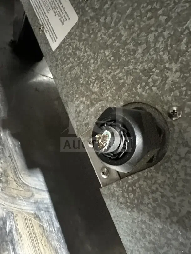 TurboChef Tornado Series commercial oven underside with exposed wiring and metal surface. Label visible on panel.