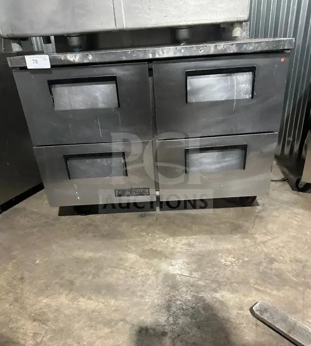 True TWT-48D-4 stainless steel undercounter refrigerator, four solid drawers, backsplash, on casters, commercial-grade.