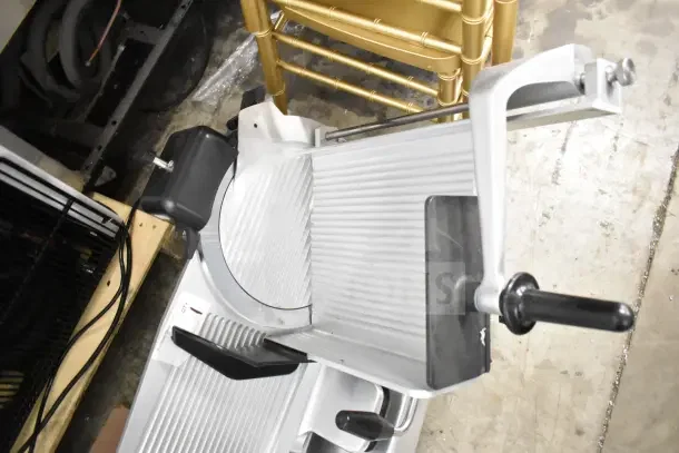 2021 Globe S13 commercial meat slicer with blade sharpener, 110V, 1 phase. Excellent condition, durable metal construction.