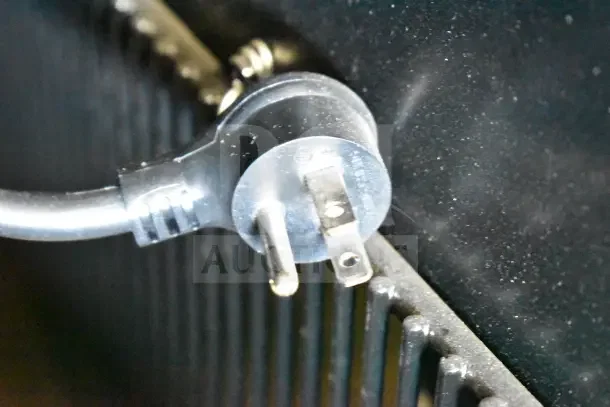 Close-up of a power plug for the True TVM-48SL-HC cooler, showing standard three-prong connection.