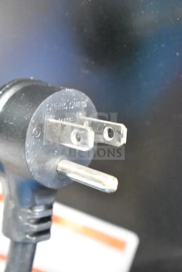 A close-up view of the plug for a True TVM-48SL-HC cooler, 115 volts, shows power connectivity detail.