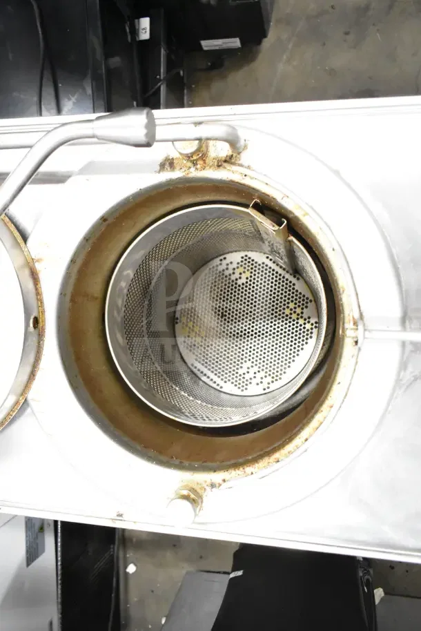 Broaster 1800 gas-powered pressure fryer in used condition, showing frying chamber with perforated basket and visible wear.