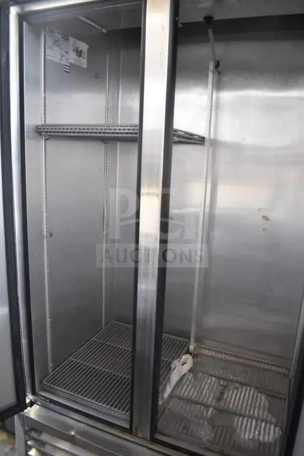 2016 True T-35 commercial 2-door reach-in cooler, stainless interior, on casters, 115 volts, 1 phase. Visible shelving.