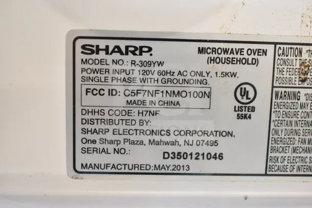 Sharp R-309YW microwave label showing model, power input of 120V, FCC ID, manufacturing date May 2013, and serial number D350121046.