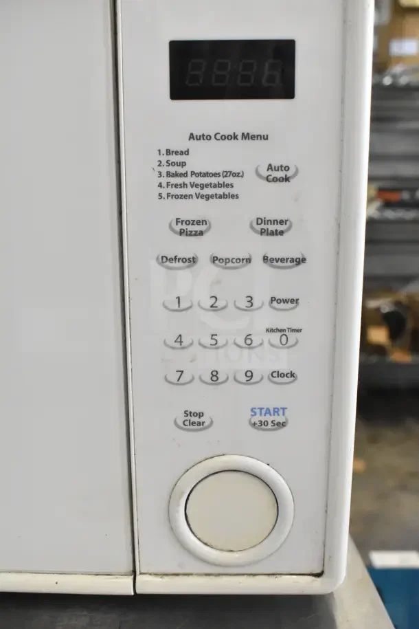 Sharp R-309YW countertop microwave oven with auto cook menu. Model R-309YW, 120 volts, 1 phase. Buttons include power levels and timer.