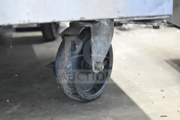 2019 Delfield GUR32BP-S work top cooler caster. Sturdy silver frame, slight wear, on concrete floor.