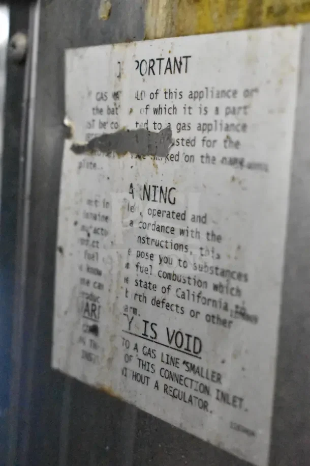 Weathered label on Commercial Gas Powered 8 Burner Range with Oven, mentioning important gas connection details and safety warnings.