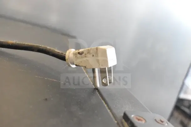 Close-up of a power plug for the True GDM-10-HC-LD Commercial Mini Cooler Merchandiser, 115 Volts, 1 Phase.