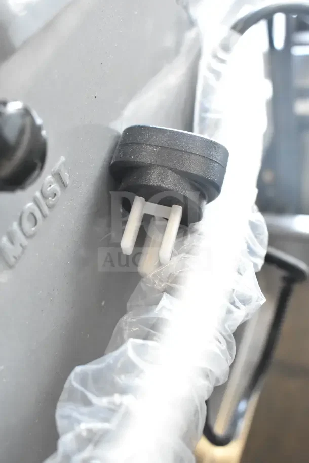 Close-up of ServIt 423WDSFS2 drawer warmer plug, showing a plastic-wrapped cord and "MOIST" label. Plug for 120V, 1 Phase.