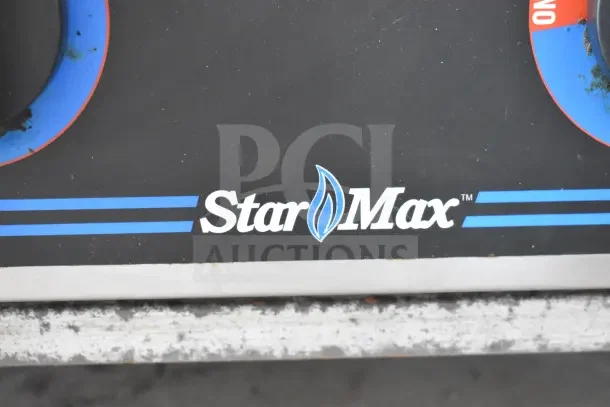 Star Max logo on commercial gas-powered 4-burner countertop range, black panel with blue accents, showing some wear.