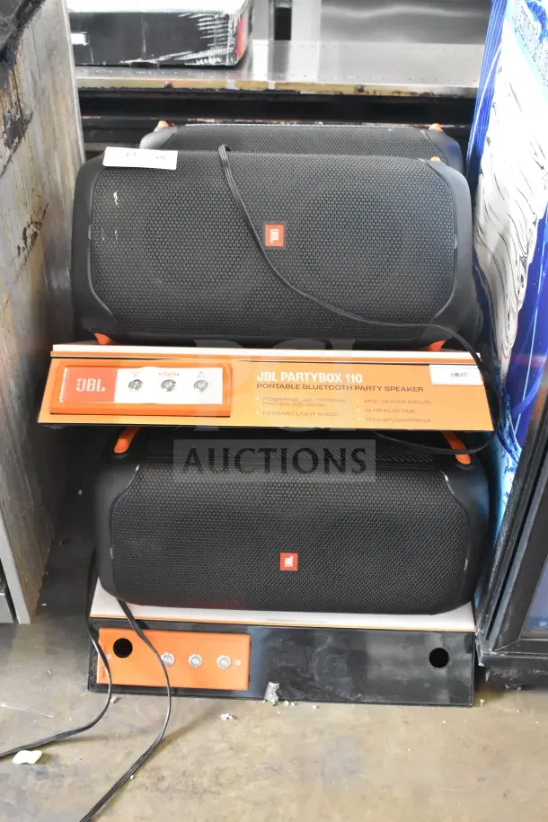4 JBL Partybox 110 Portable Bluetooth Speakers on display. Features powerful sound, dynamic light show, 12hr playtime.
