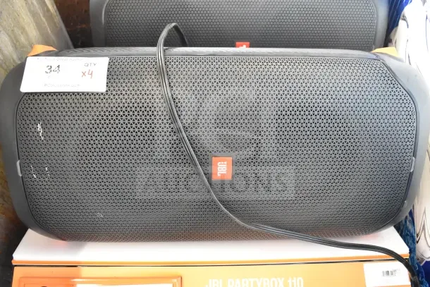 4 JBL Partybox 110 Portable Bluetooth Speakers on display. Features JBL logo, mesh grille. Tag indicates quantity 4.