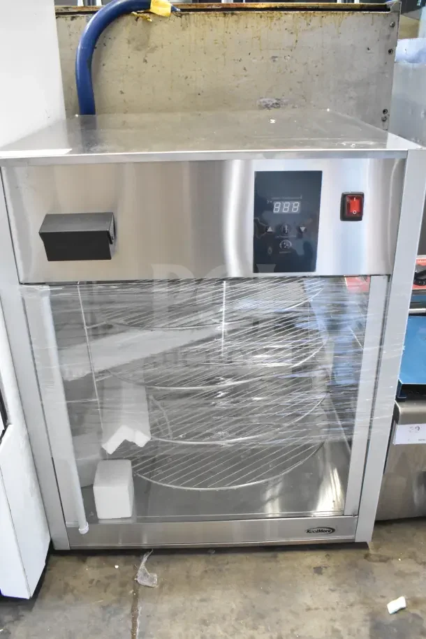 Brand new KoolMore KM-HPD4-18 pizza display warmer, 18 in., stainless steel, 4 rotating racks, 110-120V, minor scratches.
