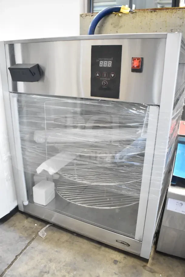 Brand new KoolMore KM-HPD4-18 pizza display warmer with 4 rotating racks, digital controls, in perfect condition.