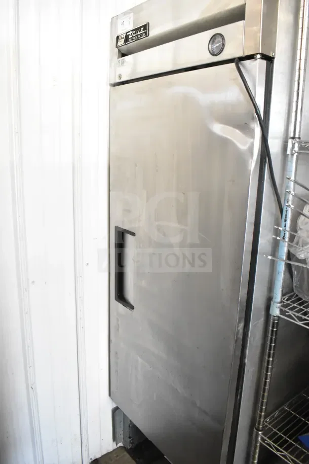 True T-23 Commercial Single Door Reach-In Cooler, stainless steel, 115 volts, 1 phase, visible True logo and temperature gauge.