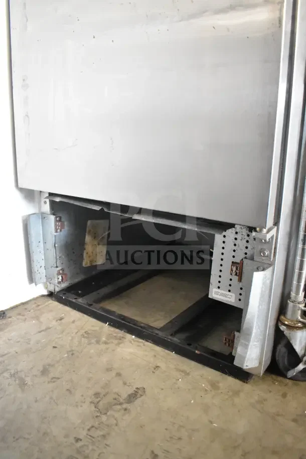 True T-23 commercial single-door reach-in cooler, 115 volts, 1 phase. Visible base, stainless steel body, good condition.