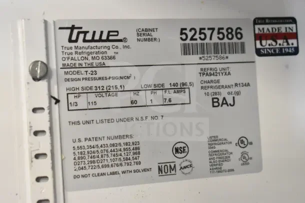 True T-23 Commercial Single Door Reach-In Cooler label indicating 115 volts, model T-23, made in the USA.