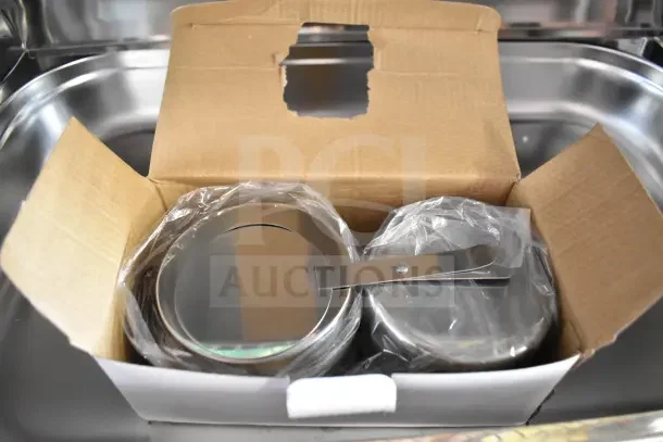 Countertop Roll Top Chafing Dish in open box, new condition, stainless steel, wrapped in plastic for protection.