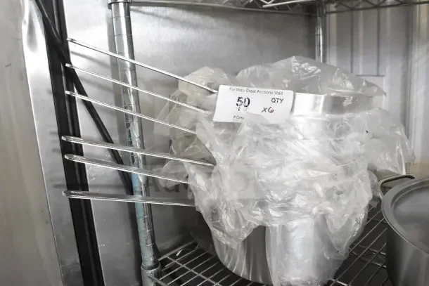 6 brand new Choice 471SAUC55QT 5.5 Qt. tapered aluminum sauce pans, slight scratches, wrapped in plastic, auction lot tag visible.